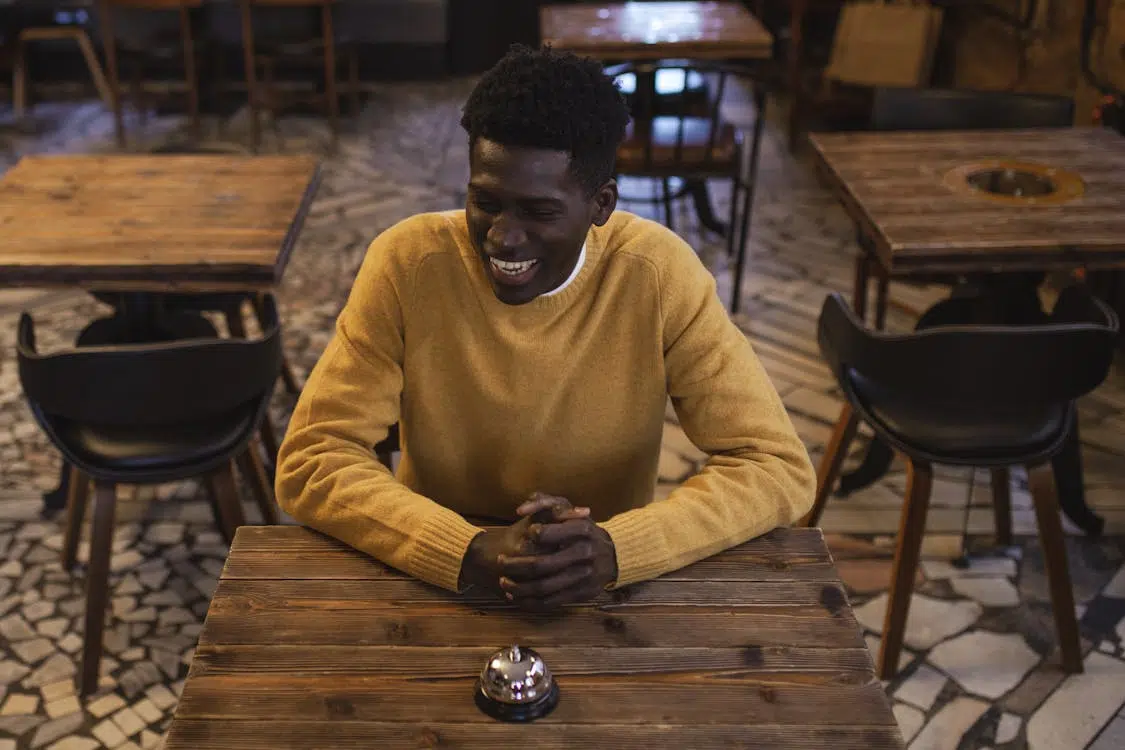 A man smiling at a table