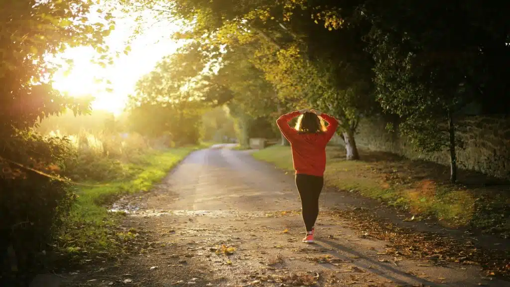 A woman walking on a pathway in the morning