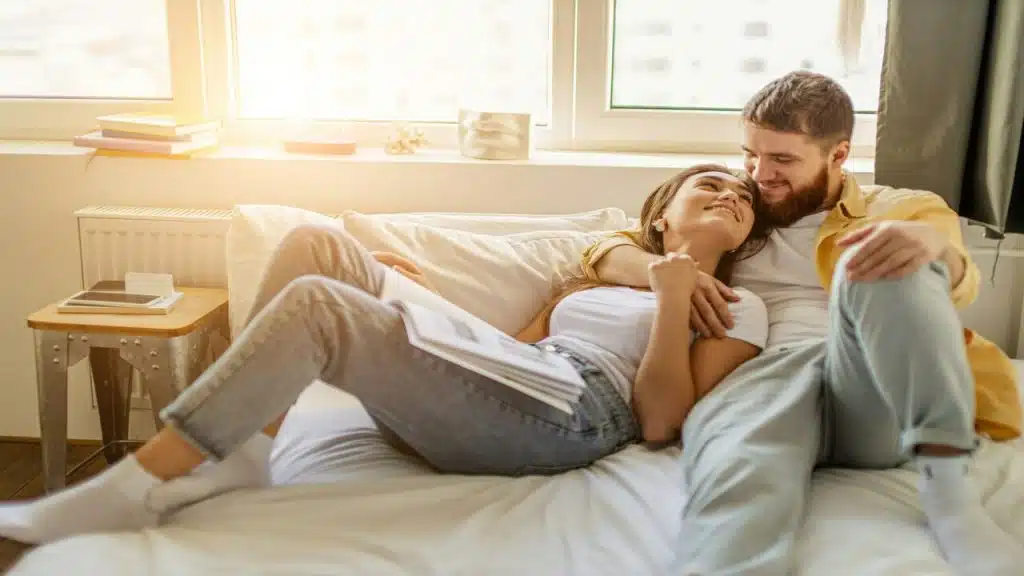 A couple cuddling on the couch