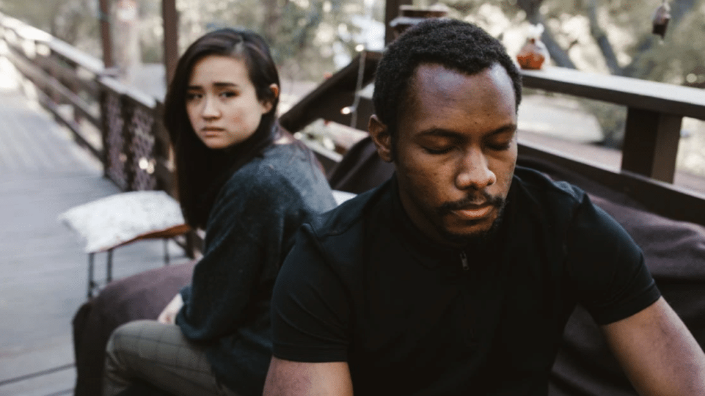 A woman looking sadly at her boyfriend
