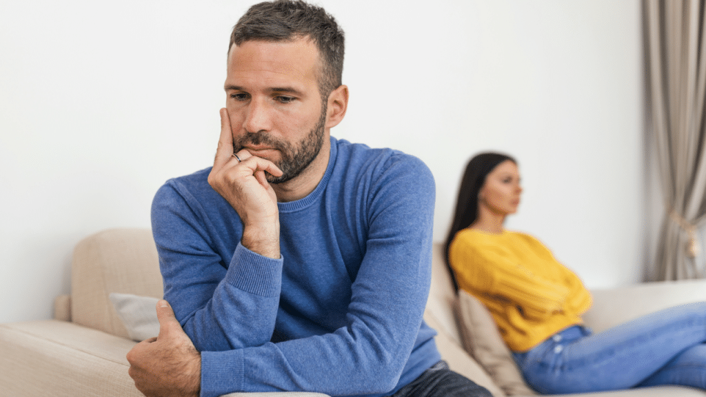 A man looking miserable at home
