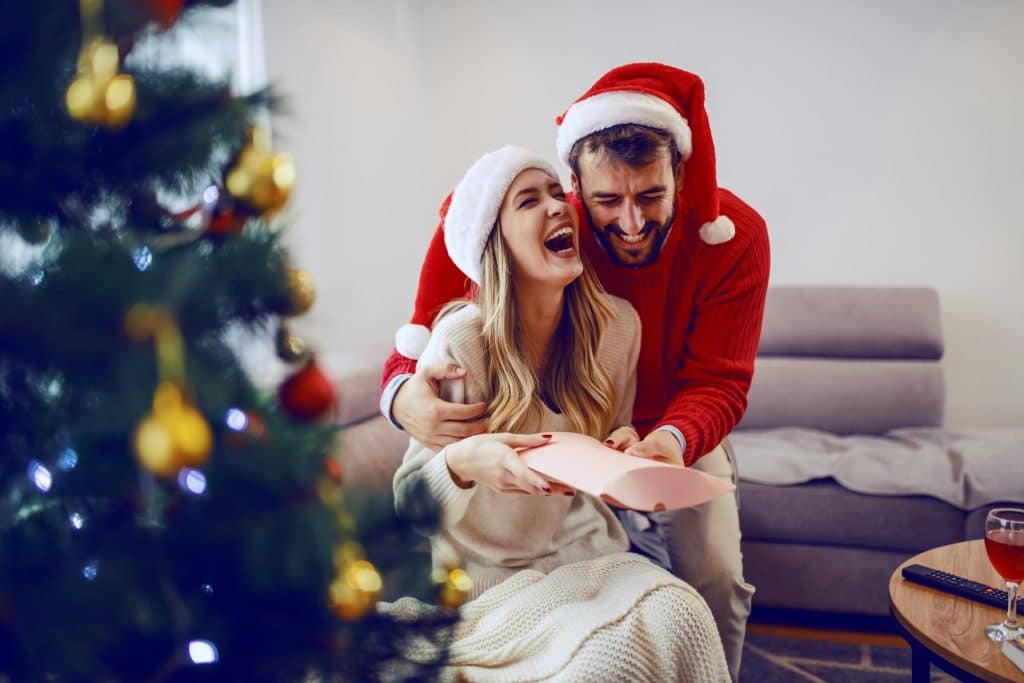 A couple laughing together in the living room.