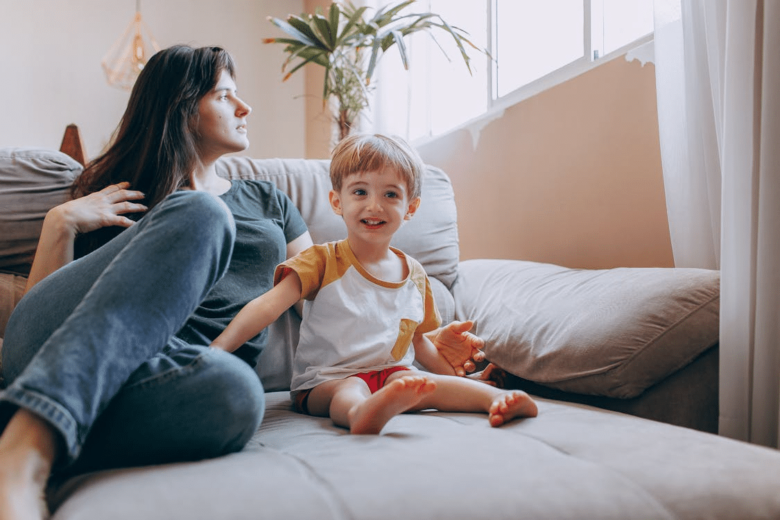 A mother and child sitting on a sofa