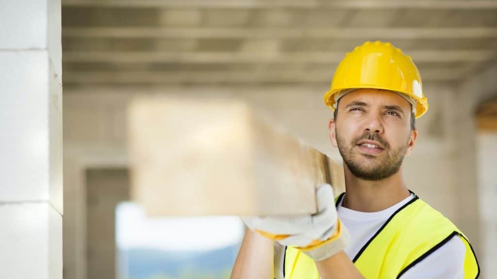 A construction worker is working on a new house.
