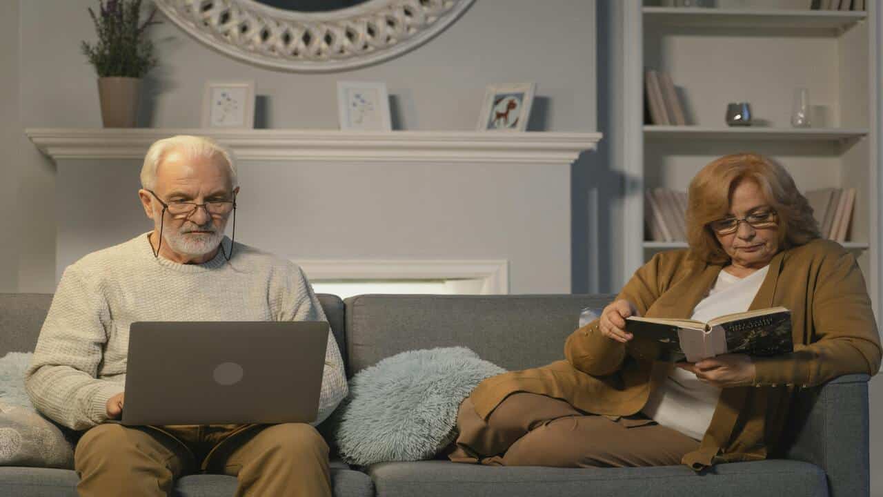 A couple both busy at home