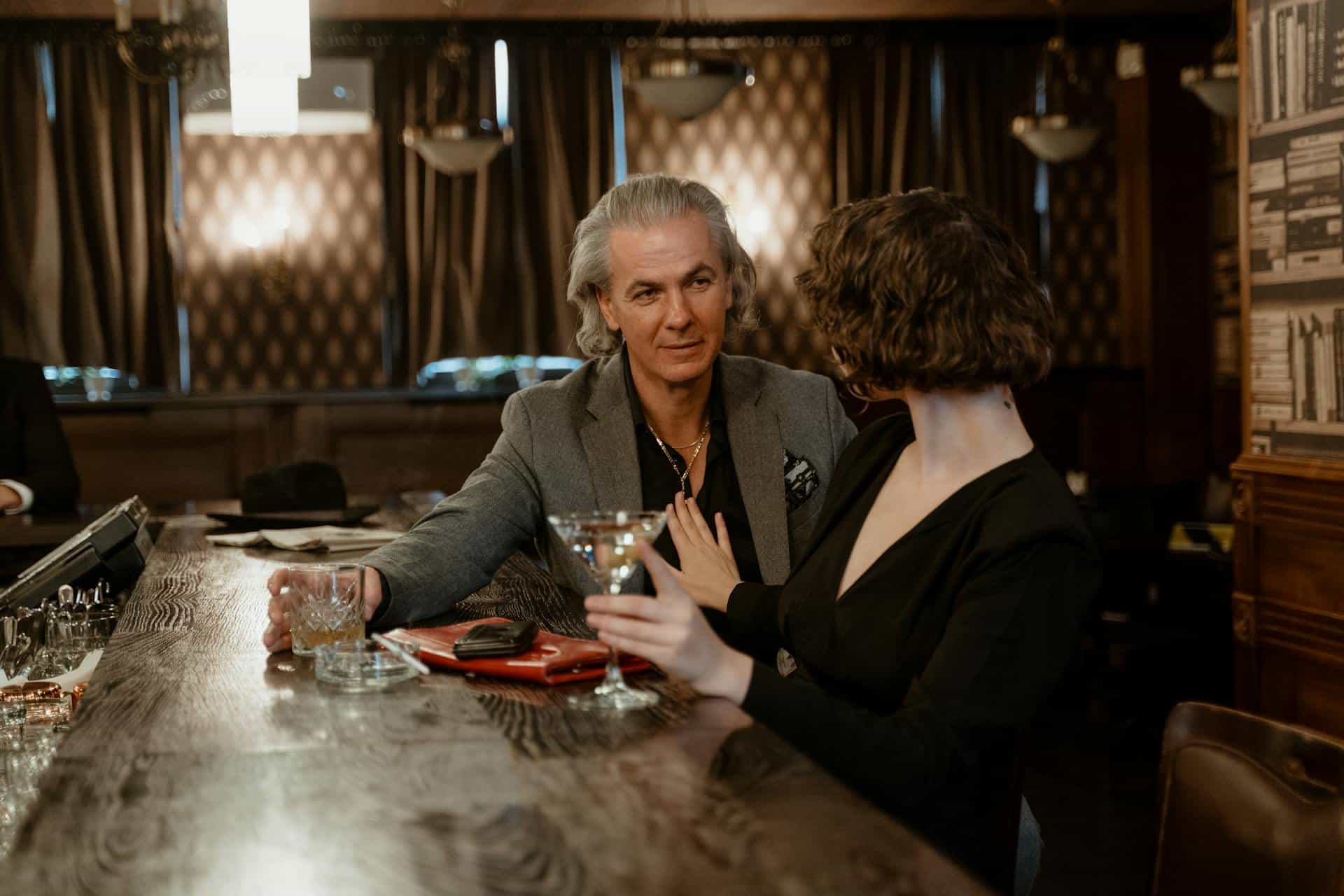 A man and woman sitting at the bar.