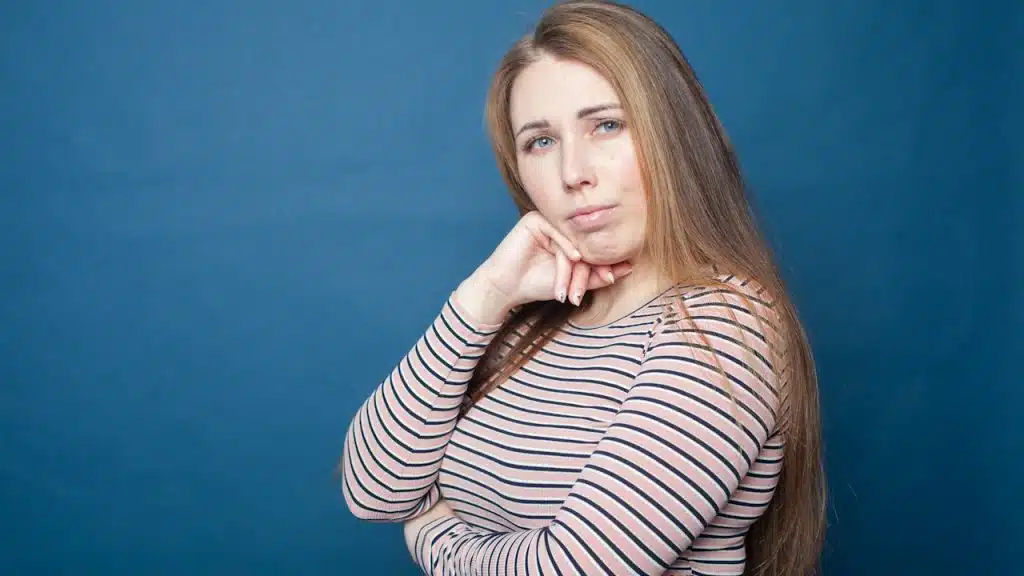 A woman with a thoughtful expression on her face.