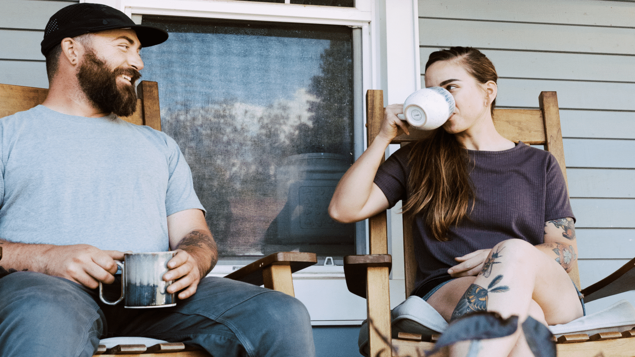 A couple talking on the porch