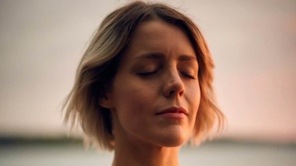 A mature woman with her eyes closed.