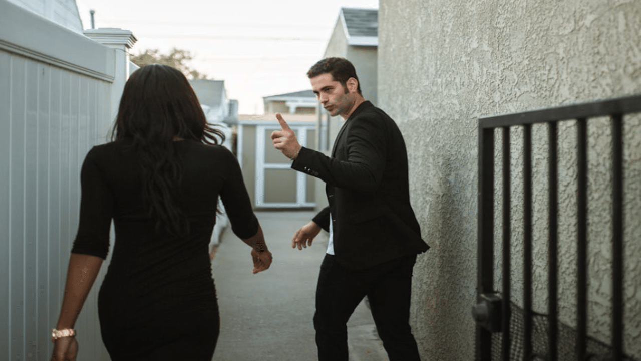 A couple fighting outside their home