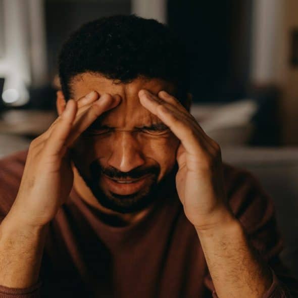 A man looking stressed at home