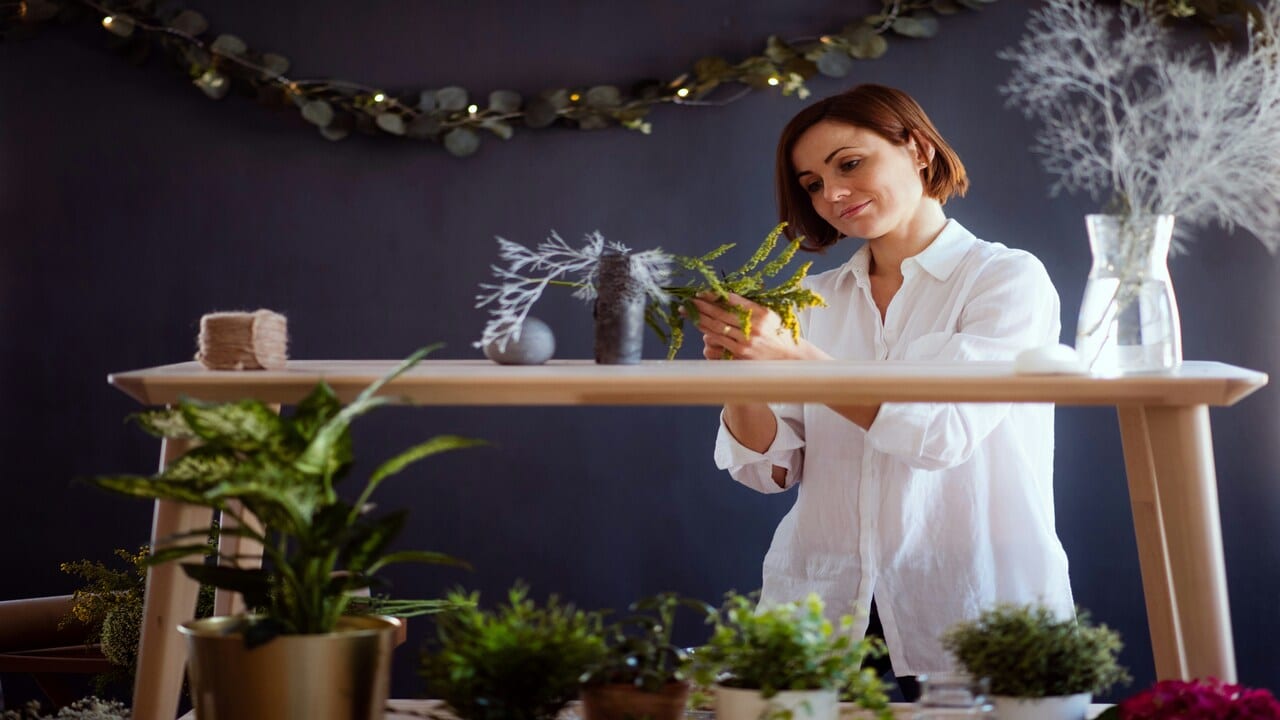 A mature woman arranging flowers