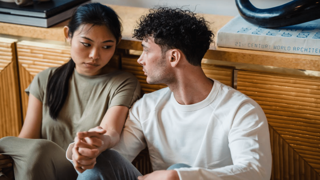 A couple talking on the floor