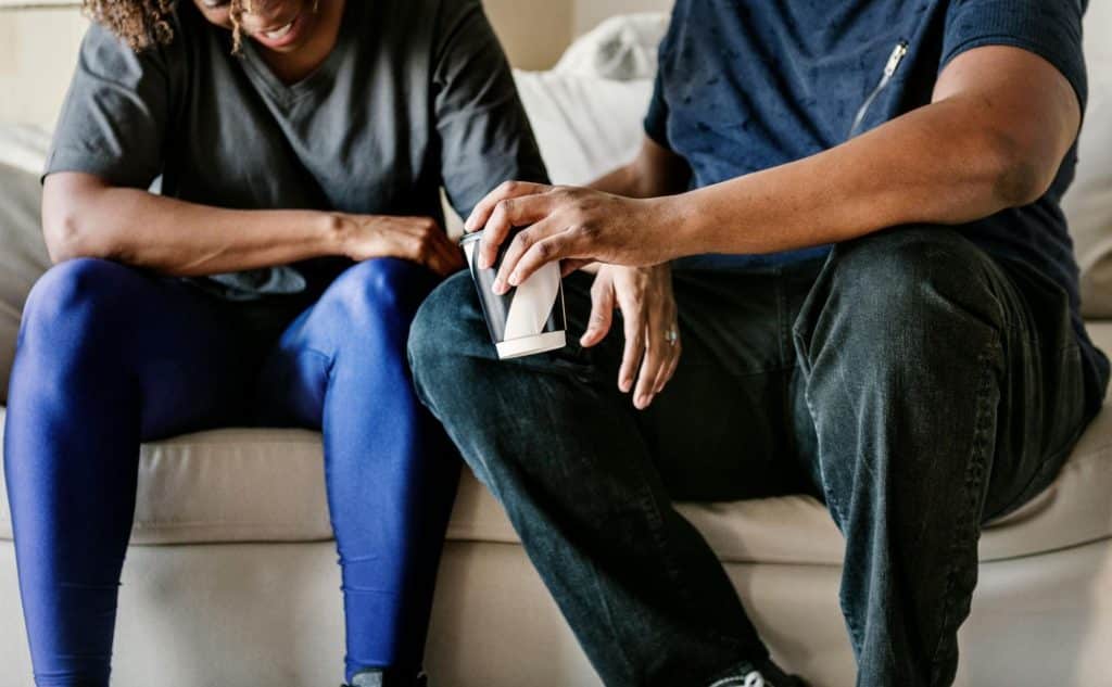 A man and woman sitting at the couch