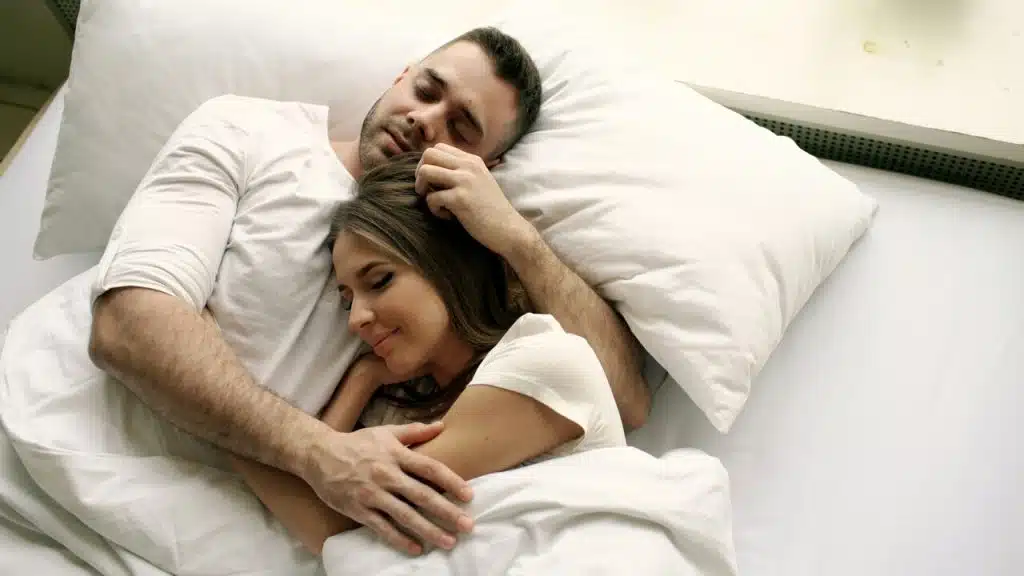 A couple sleeping peacefully in bed