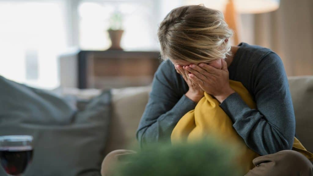 A woman crying at home