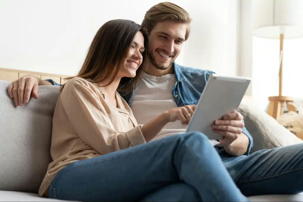 A man and woman looking at the tablet