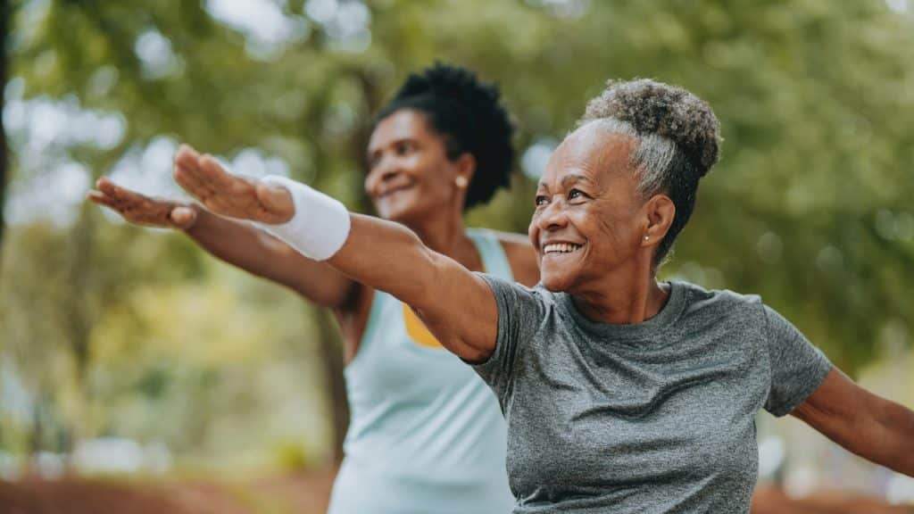 Two woman exercising in open air.