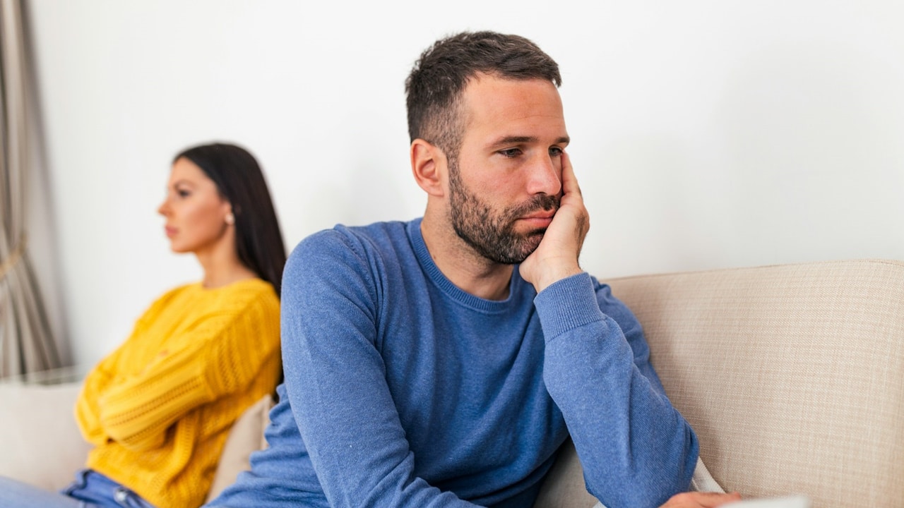An unhappy couple having an argument at home.