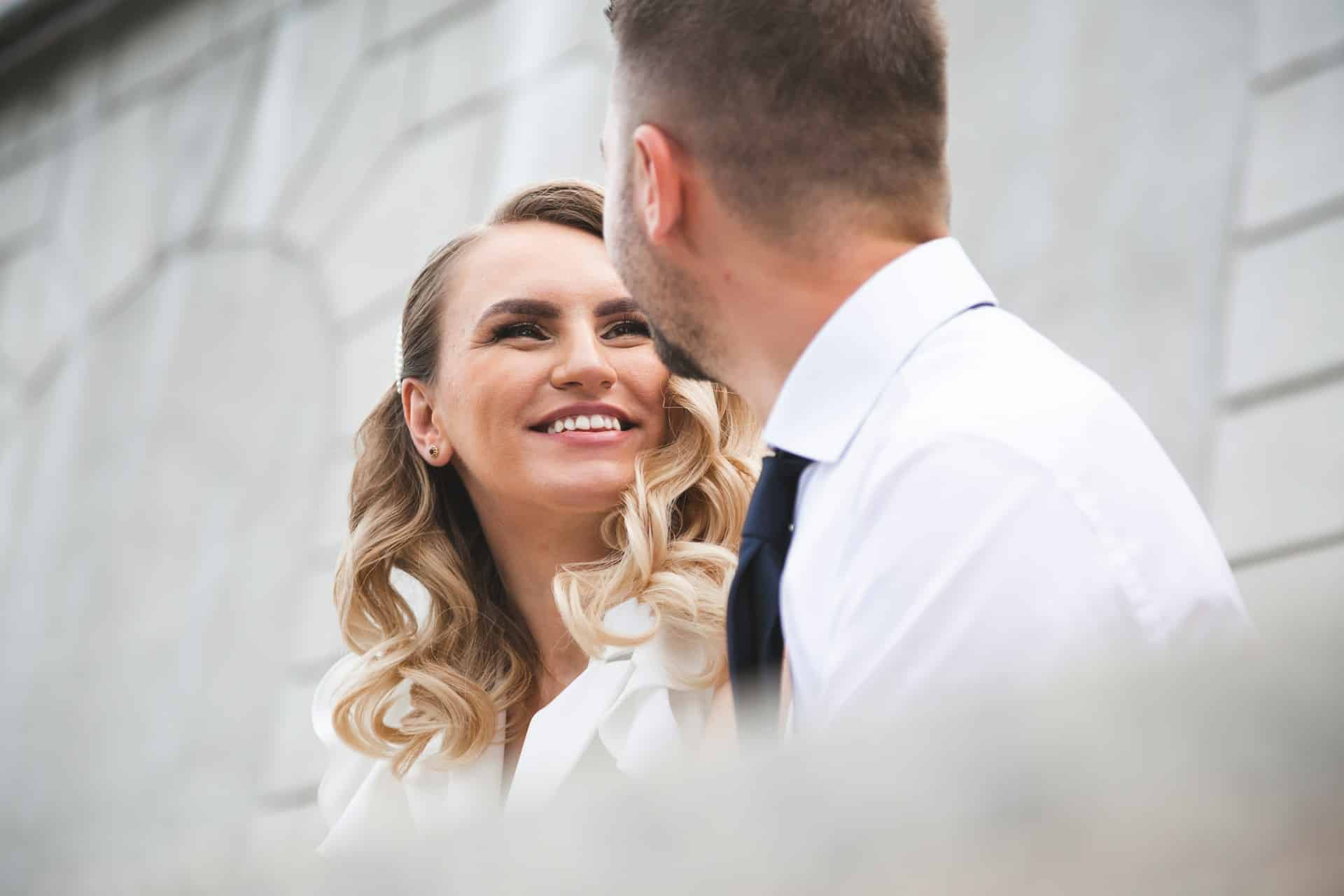 A woman and man smiling at each other.