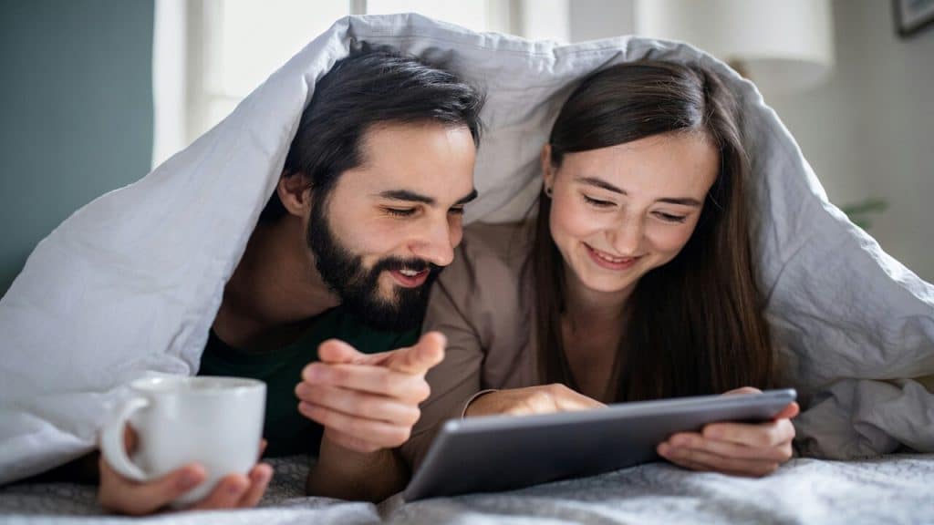 A couple looking at something on the tablet