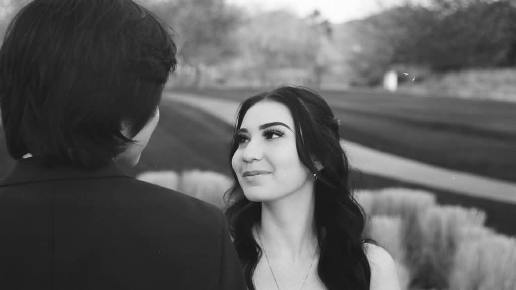 A man and woman looking at each other.