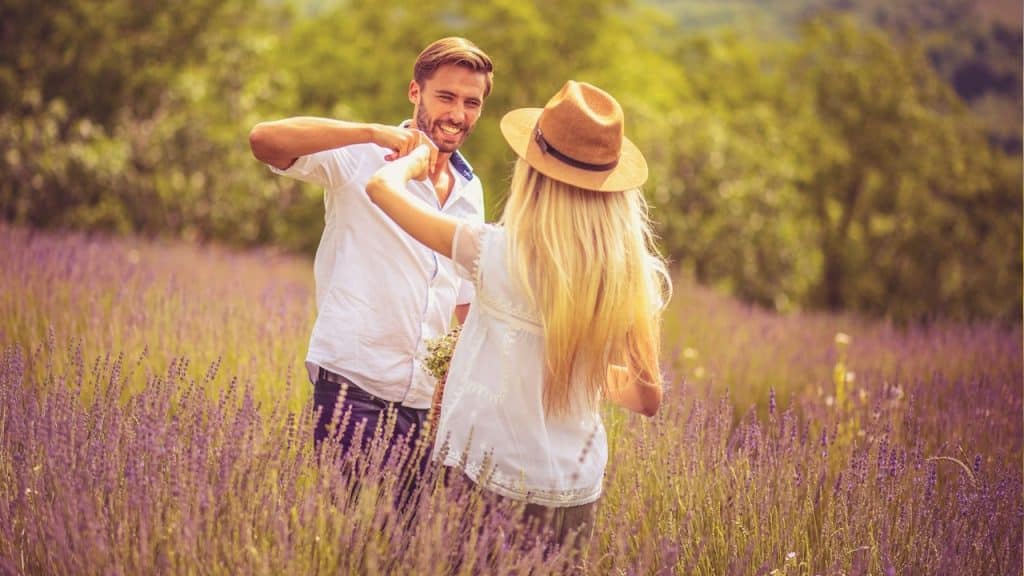 A young couple standing in a lavender field.
