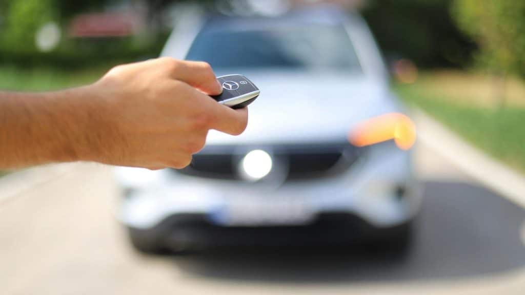 A person's hand holding a car key.