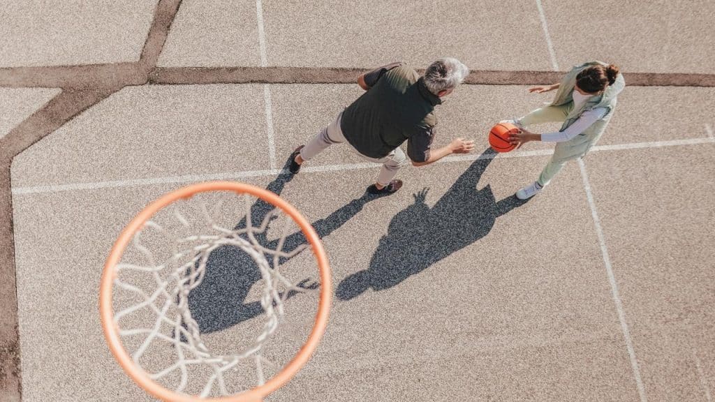A top view of two people playing basketball.