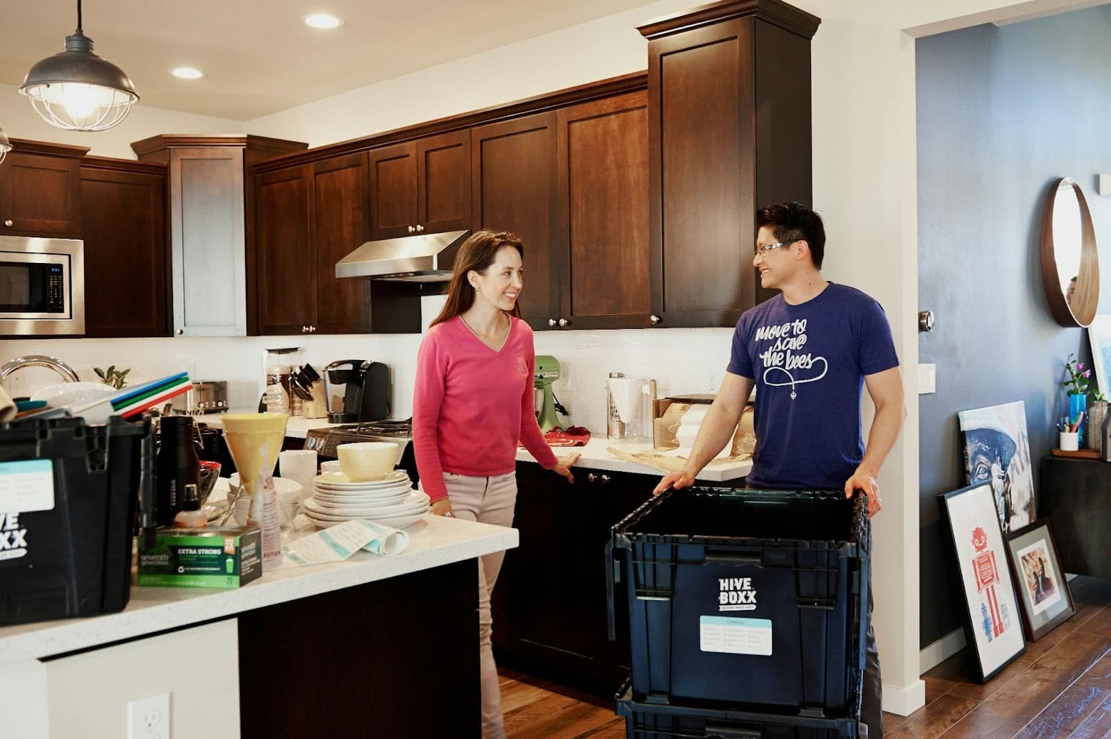 A man and woman cleaning their space