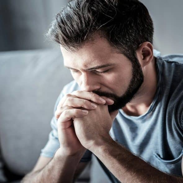 A man looking upset at home