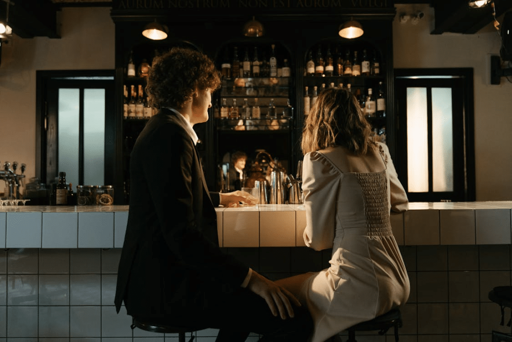 A man and a woman sitting at the bar