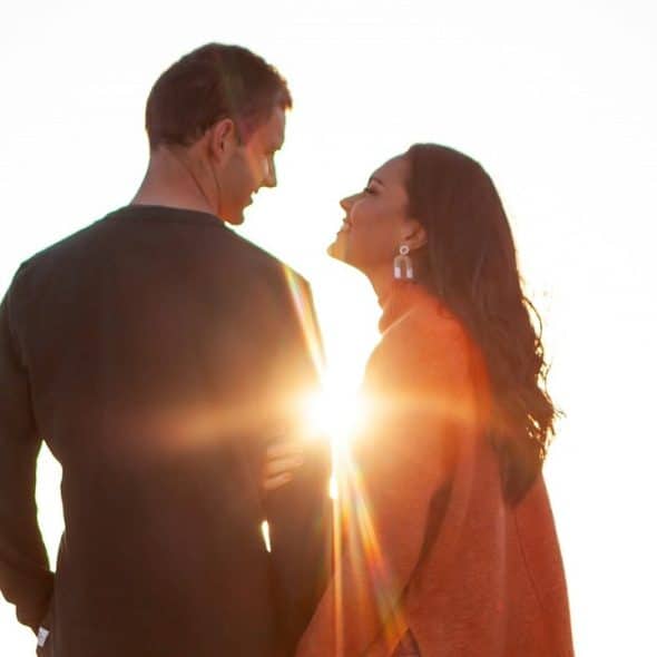 A man and woman standing outdoors during daytime.