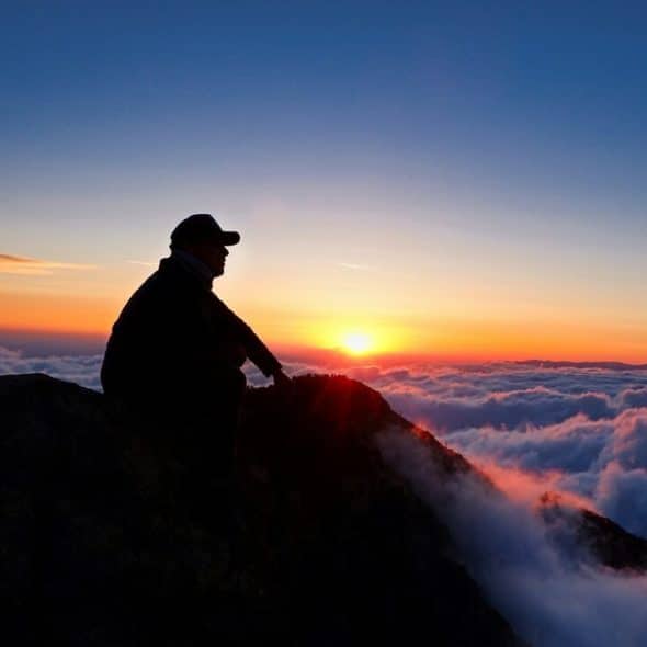 A man on top of a mountain