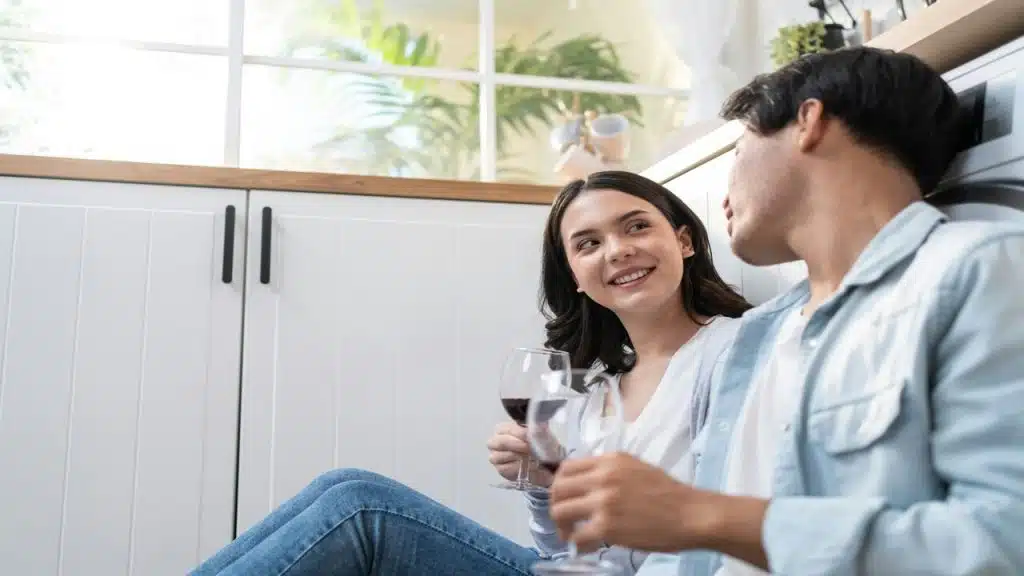 A couple having wine together at home