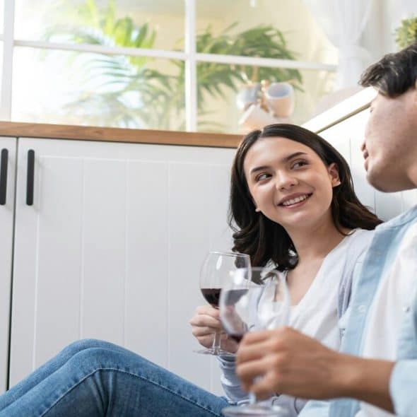 A couple having wine together at home
