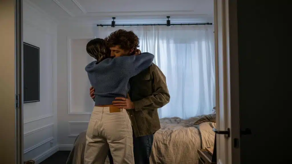A couple hugging in the living room