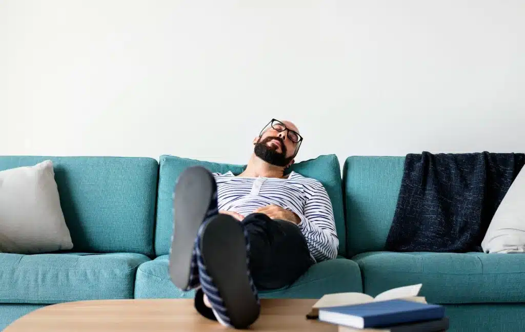 A man resting at the sofa