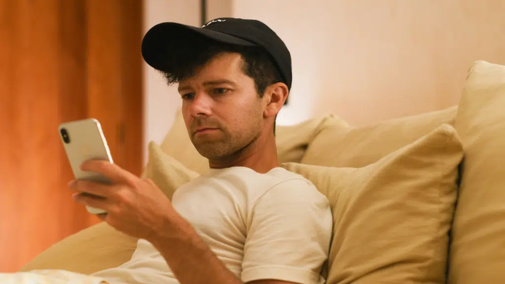 A man looking sad while texting