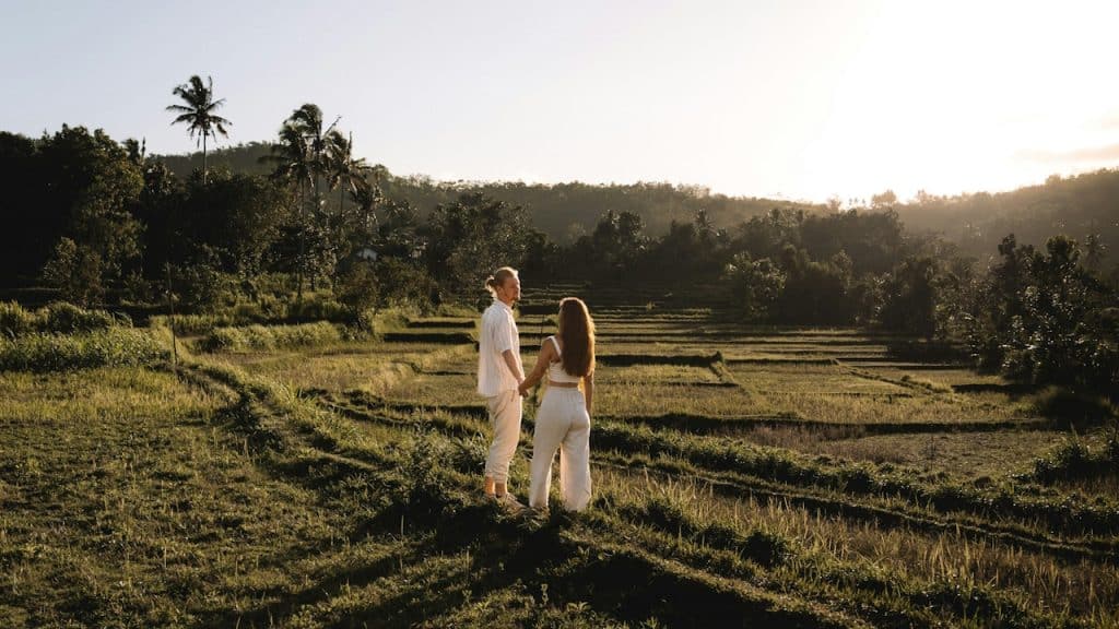 A couple of people standing in a field.