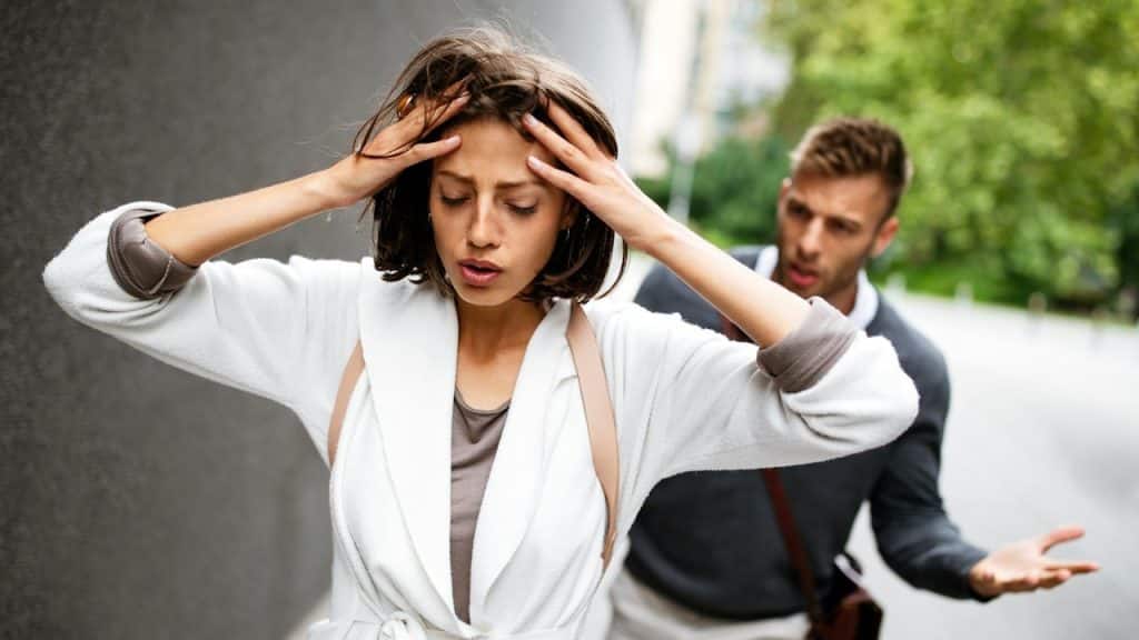 A couple having argument while they are walking outdoors.