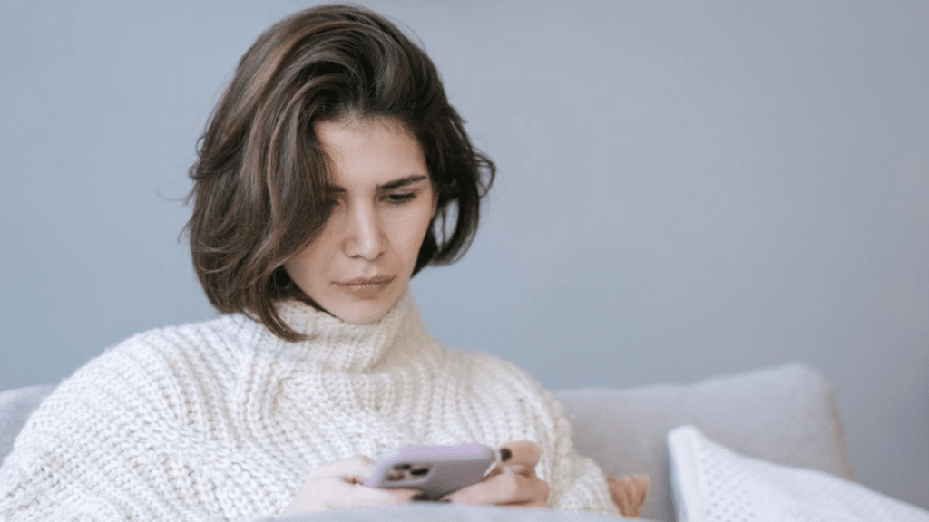 A woman waiting for a text