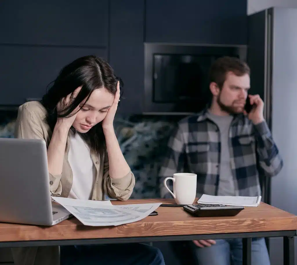 A man talking with someone over the phone while woman suffers