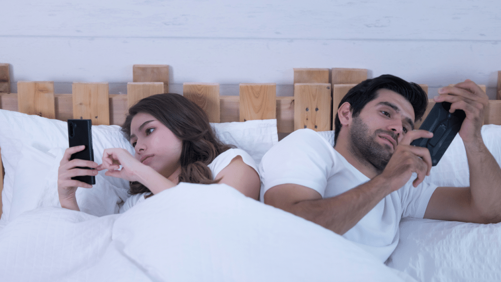 A couple ignoring each other for their phones