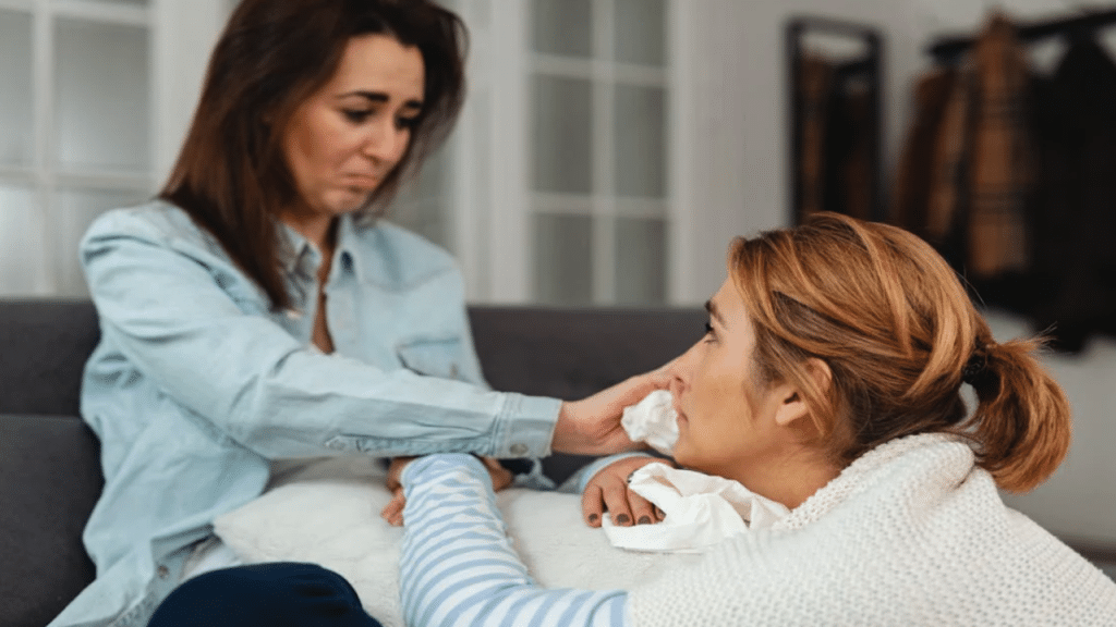 A woman wiping her friend’s tears