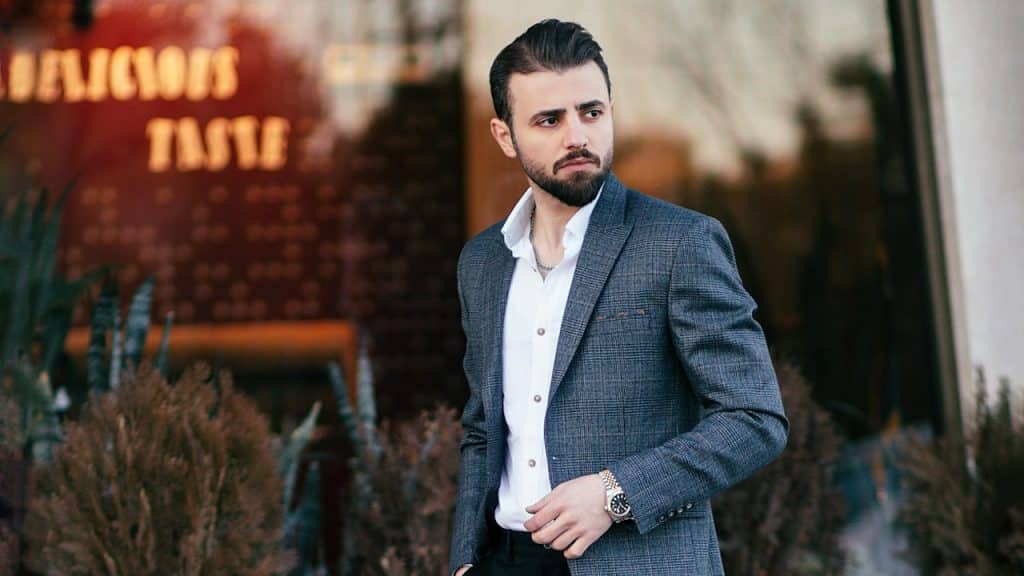 A man-in-a-suit is standing outside.