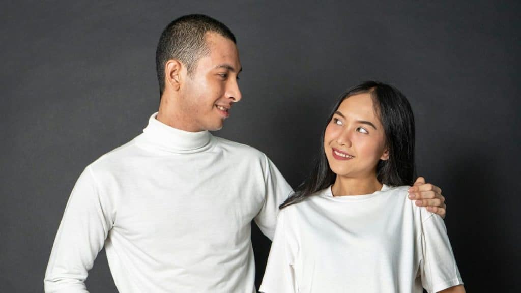 A man and a woman standing next to each other and smiling.