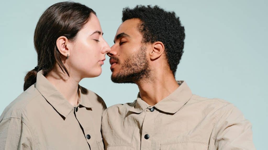A man and a woman touching noses with each other.