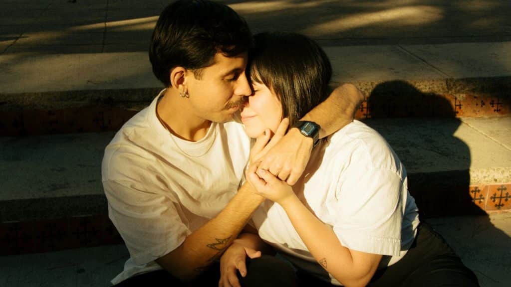 A couple is embracing affectionately and sharing a moment.