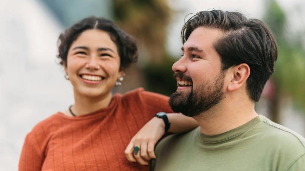 A man and a woman laughing together.